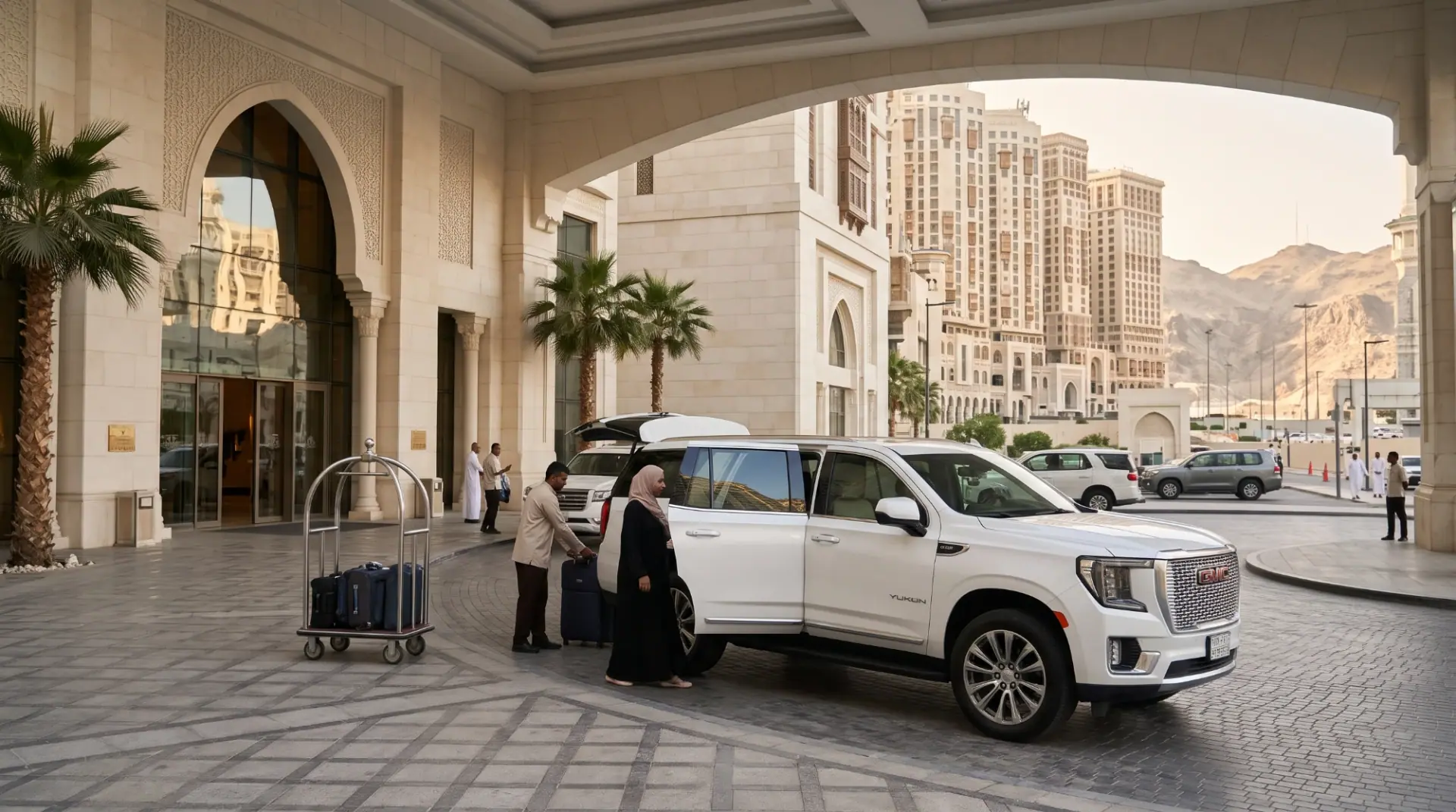 Driver loading suitcases into a white SUV at a Makkah hotel entrance